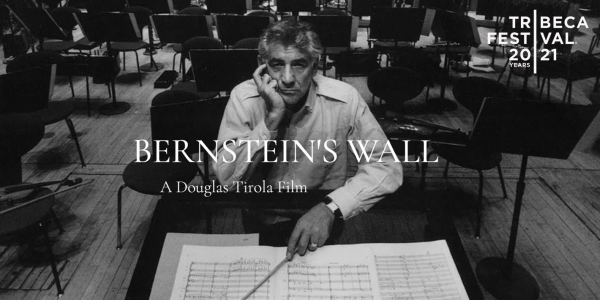 Black and White photo of Leonard Bernstein on stage at music stand. Text: Bernstein's Wall, a film by Douglas Tirola with 2021 Tribeca Film Festival Logo.