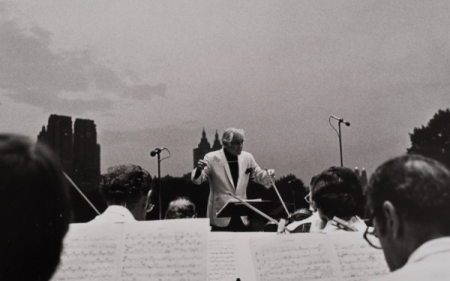 Leonard Bernstein conducting the New York Philharmonic in Central Park, July 4, 1976. Courtesy of the New York Philharmonic Digital Archives.