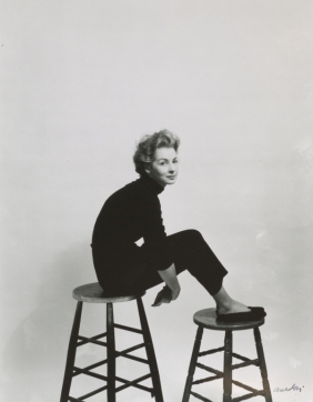 A woman sitting on stools